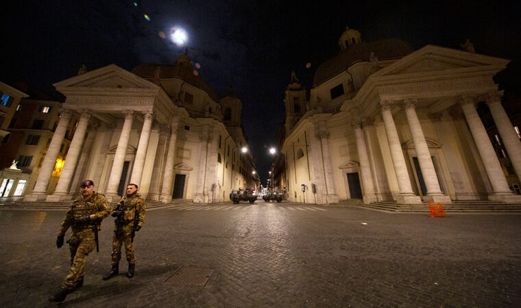 empty street in Rome with two soldiers and two tanks on patrol