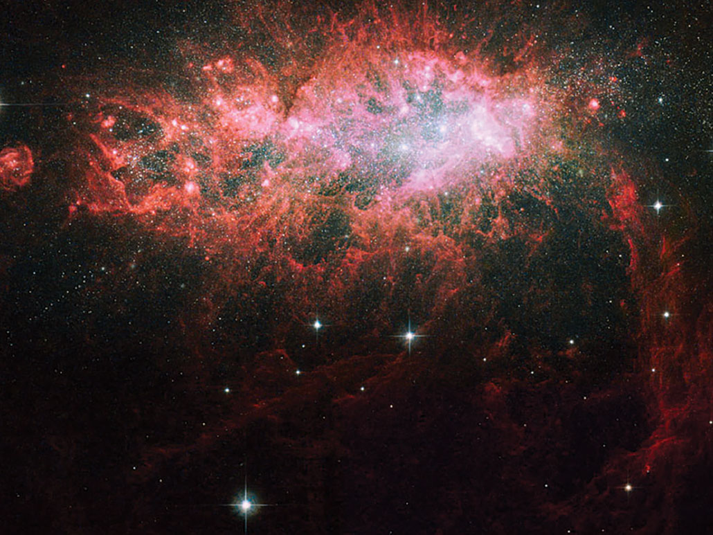 a galaxy that looks like a burst, in false-color red