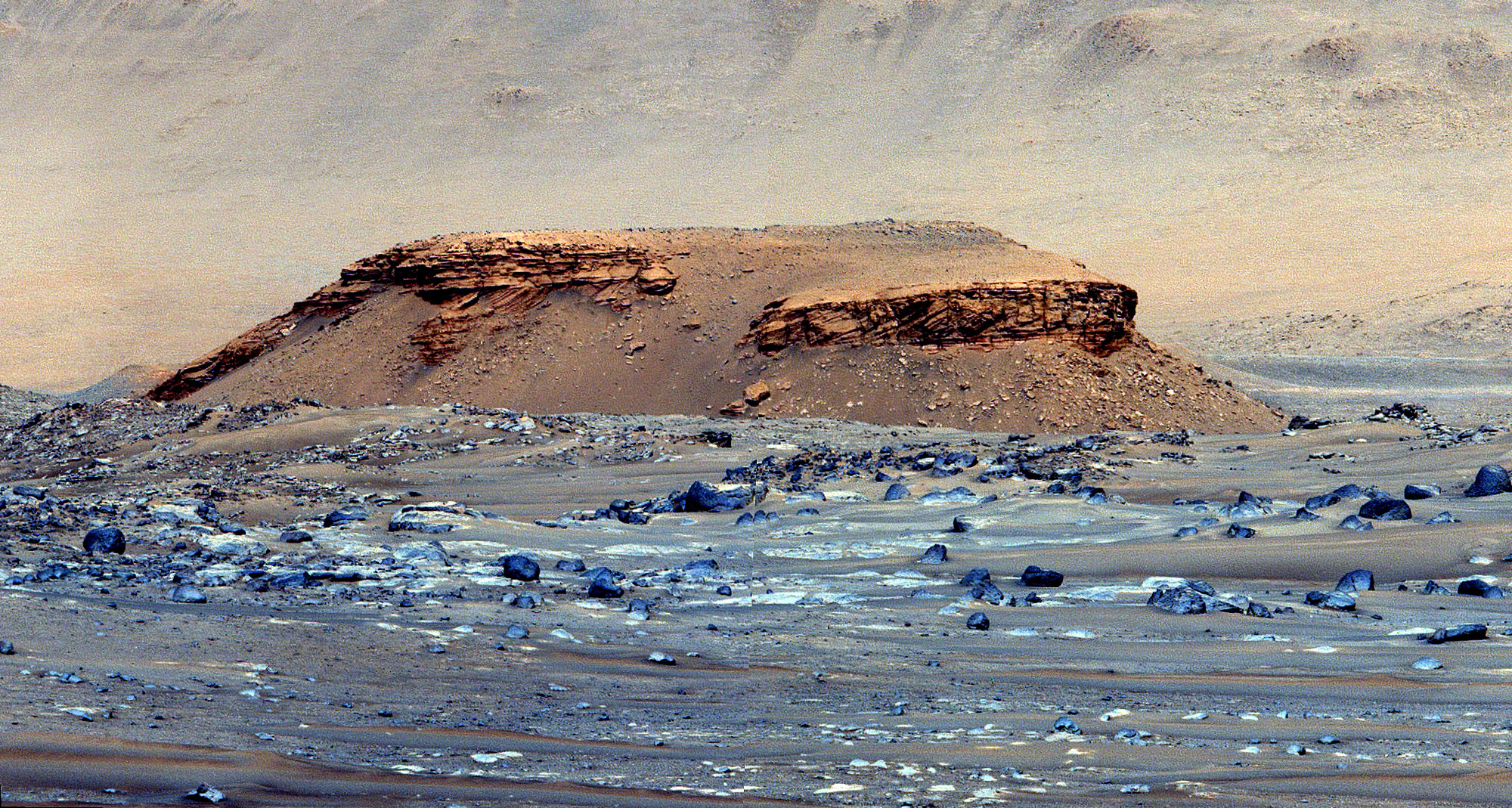 a jagged landscape with large flat-topped hill emerging from the middle