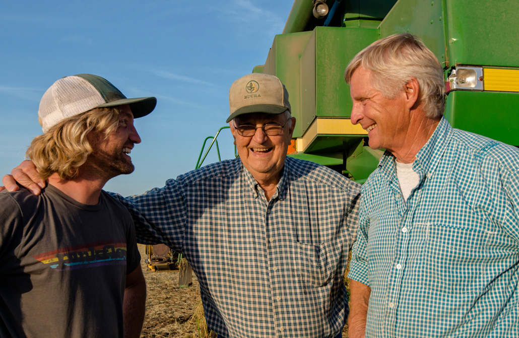 three men stand next to each other