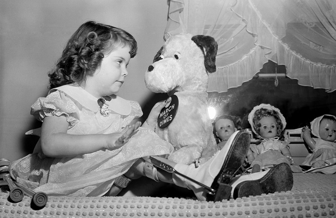 black and white image of Marlene Olsen with her toys