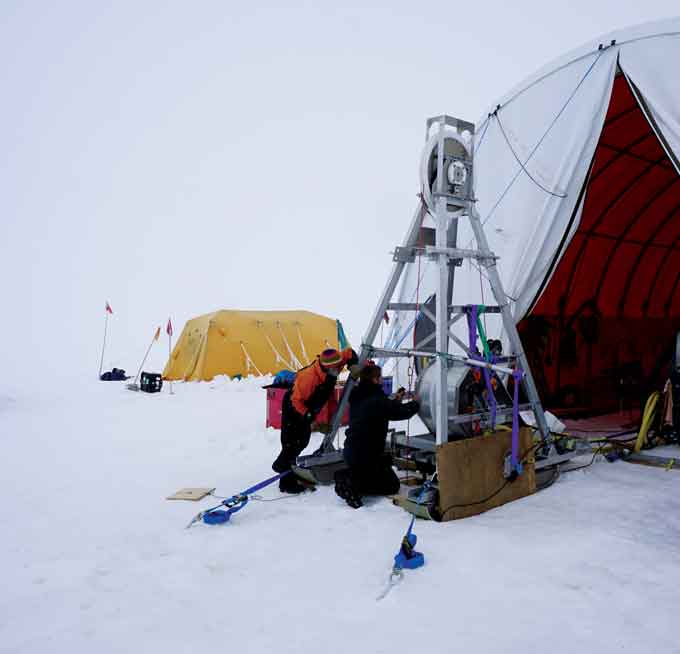 Researchers deploy instruments through a borehole into the water-filled cavern hidden beneath the Kamb Ice Stream.