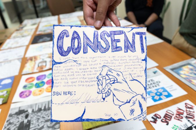 A piece of art created by a student in the Biology and Society course at ASU. It's a piece of paper discussing consent and data sovereignty and features a drawing of someone's hand forcing another hand to sign a signature line.